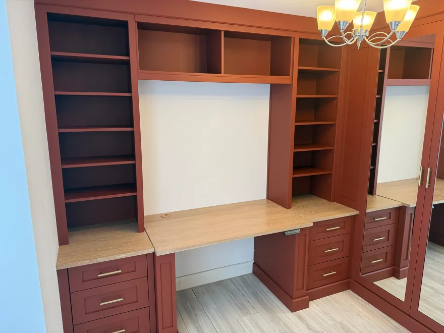 Terracotta home office with bookshelves, an oak desk and mirrored wardrobe doors
