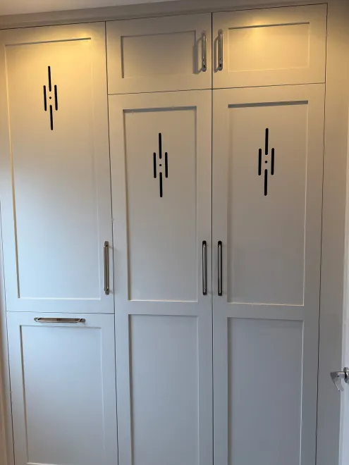Full-height painted boot room cupboards with slot vents and bar handles