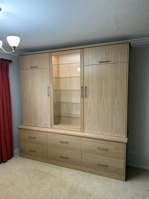 Bespoke oak dresser with a lit glass display cabinet and six drawers below