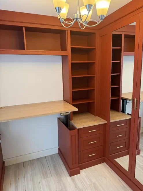 Terracotta shaker drawers and shelves beside a height-adjustable desk